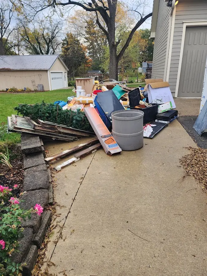 Dumpster being loaded with debris for Estate Cleanout Dumpster Rental in Carterville